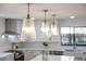 Modern kitchen lighting with a large center island and pendant lights at 4105 W Iowa Ave, Tampa, FL 33616