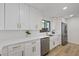 Bright, updated kitchen featuring white cabinets, quartz countertops, stainless steel appliances, and gold hardware at 4105 W Iowa Ave, Tampa, FL 33616