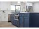 Kitchen with navy island featuring stainless steel microwave and gold hardware at 4105 W Iowa Ave, Tampa, FL 33616