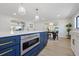 Kitchen island with stainless steel microwave featuring open concept to dining and living area at 4105 W Iowa Ave, Tampa, FL 33616
