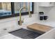 Modern kitchen sink featuring a gold faucet, white countertop, and convenient accessories at 4105 W Iowa Ave, Tampa, FL 33616