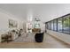 Open-concept living room with expansive windows, wood floors, and modern ceiling fan at 4105 W Iowa Ave, Tampa, FL 33616