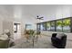 Bright living room with stylish decor, modern fan, and expansive windows at 4105 W Iowa Ave, Tampa, FL 33616