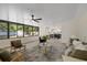 Bright living room with stylish decor, modern fan, view to dining and kitchen at 4105 W Iowa Ave, Tampa, FL 33616