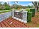 Landscaped entrance sign for Ardea Country Club with flowers and shrubbery with a view of the street at 50 Balsam Dr, Oldsmar, FL 34677