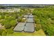 Aerial view of community tennis courts surrounded by lush trees, a peaceful and active community space at 513 Manns Harbor Dr, Apollo Beach, FL 33572