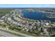 A lovely aerial view shows a charming neighborhood near a beautiful blue lake, offering serene waterfront living at 513 Manns Harbor Dr, Apollo Beach, FL 33572
