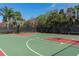 Outdoor basketball court with two hoops, black fencing and well-maintained surface offers a great playing space at 513 Manns Harbor Dr, Apollo Beach, FL 33572