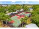 Aerial view of two fenced basketball courts, showcasing community recreational facilities with lush landscaping at 513 Manns Harbor Dr, Apollo Beach, FL 33572