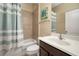This cozy bathroom includes a tiled shower and modern vanity and sink at 513 Manns Harbor Dr, Apollo Beach, FL 33572
