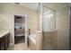 Modern bathroom showcasing a large tub, glass enclosed shower, and tiled walls for a luxurious feel at 513 Manns Harbor Dr, Apollo Beach, FL 33572