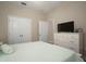 This bedroom showcases a white dresser with television and a bright window at 513 Manns Harbor Dr, Apollo Beach, FL 33572