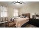 A cozy bedroom features an elegant bed frame, hardwood floors, and two decorative ottomans at 513 Manns Harbor Dr, Apollo Beach, FL 33572