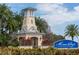 Charming entrance to gated community with lighthouse architectural detail and lush landscaping at 513 Manns Harbor Dr, Apollo Beach, FL 33572