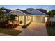 Charming one-story home with covered porch, large garage, and well-manicured landscaping, enhancing curb appeal at 513 Manns Harbor Dr, Apollo Beach, FL 33572
