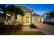 Inviting home exterior featuring a well-manicured lawn, lovely landscaping, and an attached two-car garage at 513 Manns Harbor Dr, Apollo Beach, FL 33572