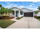 Charming single-Gathering home with a screened garage, tropical landscaping and a cozy porch at 513 Manns Harbor Dr, Apollo Beach, FL 33572