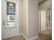 Bright foyer with glass door entry, tile floors, and view of the adjacent bathroom at 513 Manns Harbor Dr, Apollo Beach, FL 33572