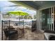 Comfortable seating on screened-in lanai with shade umbrella, perfect for relaxing by the pool at 513 Manns Harbor Dr, Apollo Beach, FL 33572