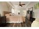 Spacious main bedroom with tray ceiling, ceiling fan, and wood-look floors at 513 Manns Harbor Dr, Apollo Beach, FL 33572