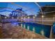 Relaxing pool area with water feature, screened enclosure, brick pavers, and outdoor lounge seating at 513 Manns Harbor Dr, Apollo Beach, FL 33572