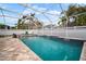 Private screened-in pool featuring a waterfall and a spacious deck area perfect for entertaining at 513 Manns Harbor Dr, Apollo Beach, FL 33572