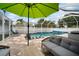 Inviting screened pool area featuring comfortable seating and an umbrella for a relaxing outdoor experience at 513 Manns Harbor Dr, Apollo Beach, FL 33572