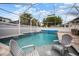 Screened pool with waterfall feature and seating area at 513 Manns Harbor Dr, Apollo Beach, FL 33572