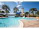 Resort-style community pool area with a slide and lighthouse detail, set amidst tropical landscaping at 513 Manns Harbor Dr, Apollo Beach, FL 33572
