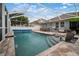 Backyard pool area with outdoor seating and cooking space at 513 Manns Harbor Dr, Apollo Beach, FL 33572