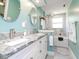 Bright bathroom with dual sinks, granite countertops, white cabinets, and a shower and tub combo at 5433 Palmetto Rd, New Port Richey, FL 34652