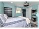 Bedroom with light blue walls, wood-look flooring, lots of natural light, and plenty of storage space at 5433 Palmetto Rd, New Port Richey, FL 34652