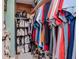 Walk-in closet with shelves, hanging rods, and ample storage for clothes, shoes, and bags at 5433 Palmetto Rd, New Port Richey, FL 34652
