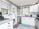 Well-lit kitchen featuring white cabinets, stainless steel appliances, granite countertops, and a stylish backsplash at 5433 Palmetto Rd, New Port Richey, FL 34652