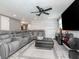 Spacious living room with an oversized leather sectional, a large ottoman, and contemporary decor at 5433 Palmetto Rd, New Port Richey, FL 34652