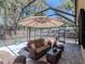 Outdoor patio area with comfortable seating and a view of surrounding trees, ideal for relaxing at 5433 Palmetto Rd, New Port Richey, FL 34652
