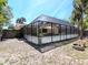 Exterior view of the spacious screened-in patio, perfect for enjoying the outdoors at 5433 Palmetto Rd, New Port Richey, FL 34652