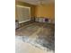 Bare living room exhibiting visible wall damage, an overhead ceiling fan, and a large window at 5706 River Terrace, Tampa, FL 33604