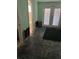 Unfinished living room featuring damaged drywall, and a door to the patio at 5706 River Terrace, Tampa, FL 33604