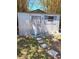 Exterior view of shed with a metal exterior, window, and small decorations at 5706 River Terrace, Tampa, FL 33604