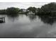 Waterfront view features a boat docked along the shoreline and peaceful, serene surroundings at 5706 River Terrace, Tampa, FL 33604