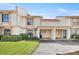Townhome with an attached carport, lush lawn, tidy landscaping, and a quaint entry at 6140 Sun Blvd # 5, St Petersburg, FL 33715