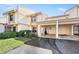 Townhome featuring a private carport, and a well-manicured lawn with colorful decorations at 6140 Sun Blvd # 5, St Petersburg, FL 33715
