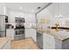 Bright kitchen featuring white cabinets, granite countertops, stainless steel appliances, and tile floors at 6140 Sun Blvd # 5, St Petersburg, FL 33715