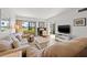 A living room featuring tile flooring, comfortable seating, and a fireplace with sliding glass doors at 6140 Sun Blvd # 5, St Petersburg, FL 33715