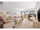 Bright living room with tile floors, comfortable seating, and a view of the landscaped backyard at 6140 Sun Blvd # 5, St Petersburg, FL 33715