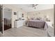 Bright main bedroom featuring calming decor, a ceiling fan, and a view into an additional room at 6140 Sun Blvd # 5, St Petersburg, FL 33715