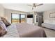 Spacious bedroom with ceiling fan, a golf course view, and additional seating at 6140 Sun Blvd # 5, St Petersburg, FL 33715
