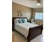 Charming bedroom with a queen-sized bed, decorative pillows, and a comfortable reading chair at 6201 2Nd E St # 89, St Pete Beach, FL 33706