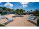 Courtyard with palm trees, lounging chairs, and tables, creating an inviting outdoor space at 6201 2Nd E St # 89, St Pete Beach, FL 33706